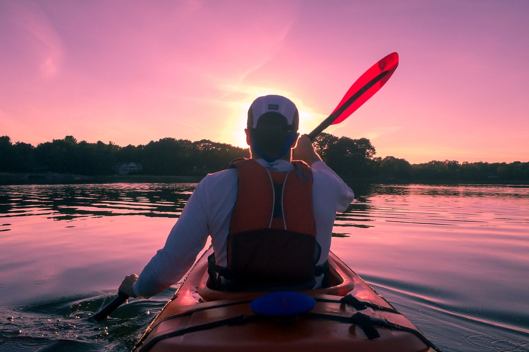 Main kayaking into the purple sunset
